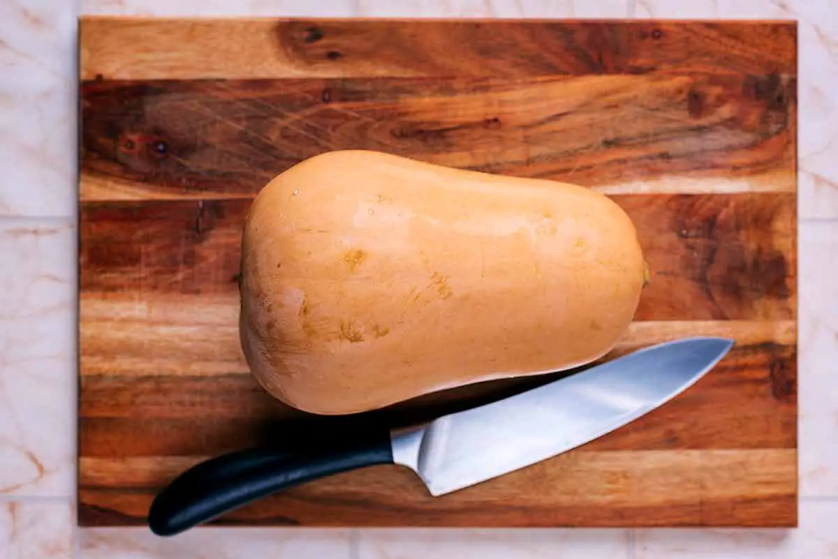 A butternut squash with its top sliced off.