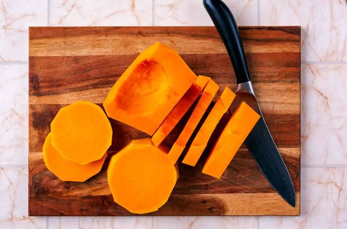 A peeled butternut squash cut into slices.