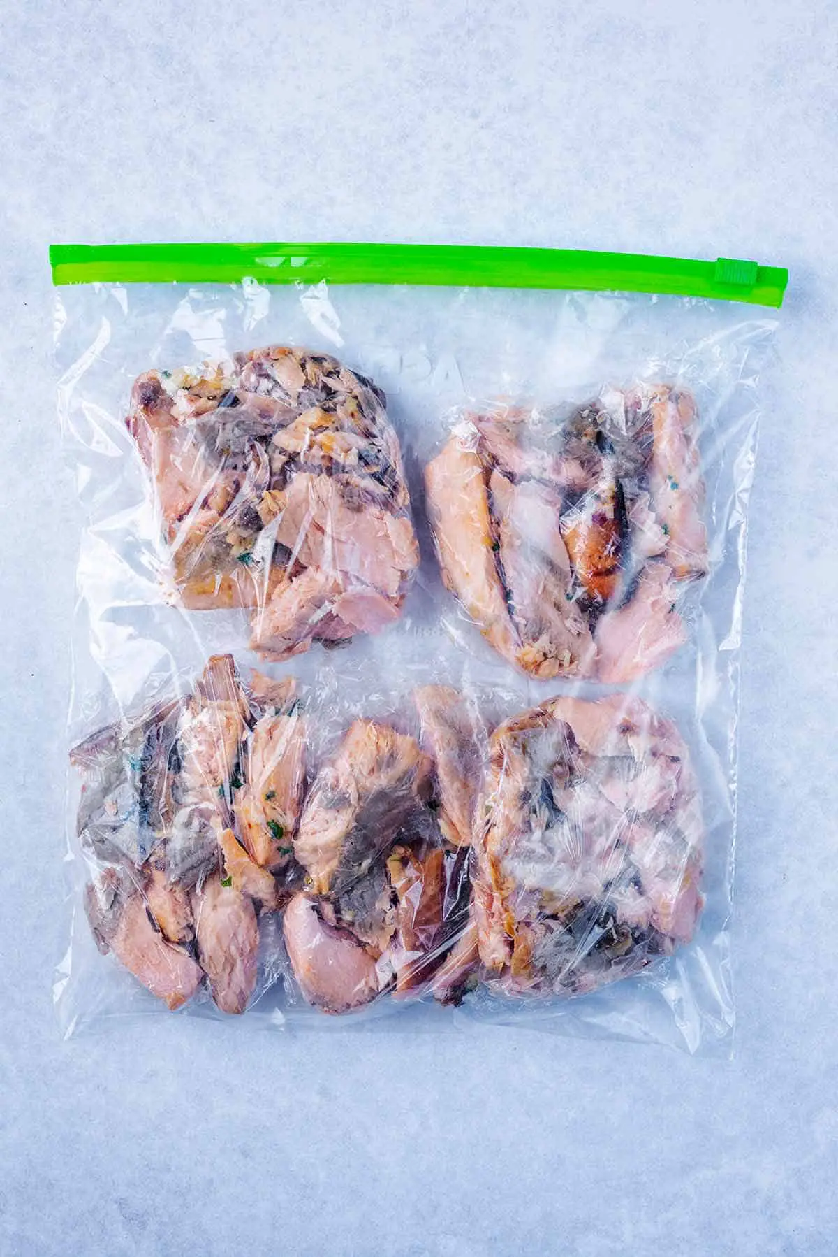 A ziploc freezer bag containing wrapped portions of salmon.