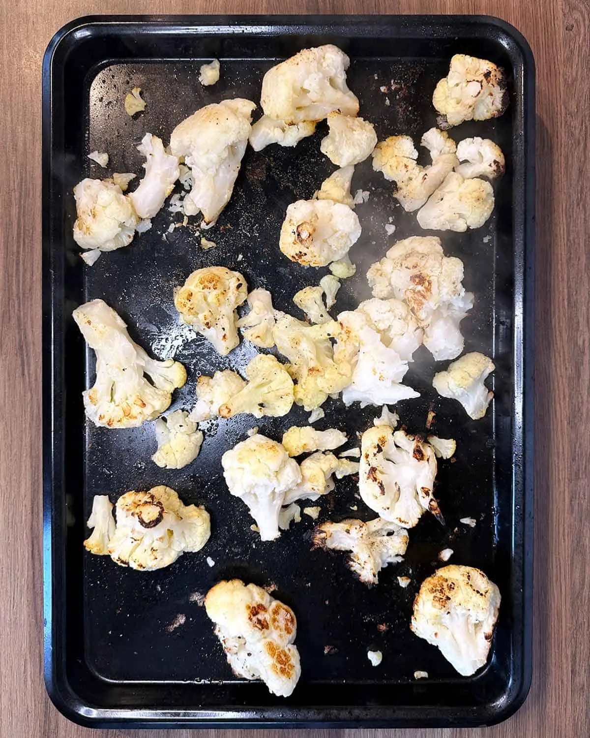 Oil and seasoning added to the cauliflower florets.